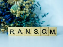 a wooden block spelling the word random next to a bouquet of flowers