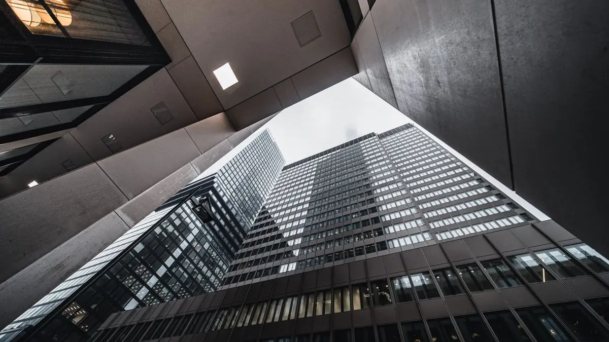 Modern glass towers viewed from below.
