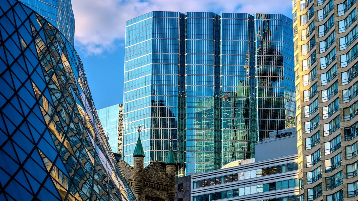 Glass skyscrapers reflecting the blue sky.