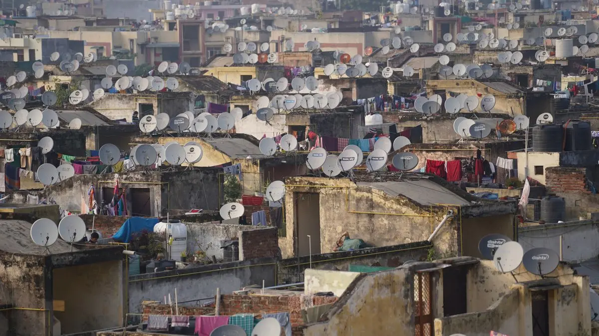 Satellite dishes on rooftops in an Indian city.