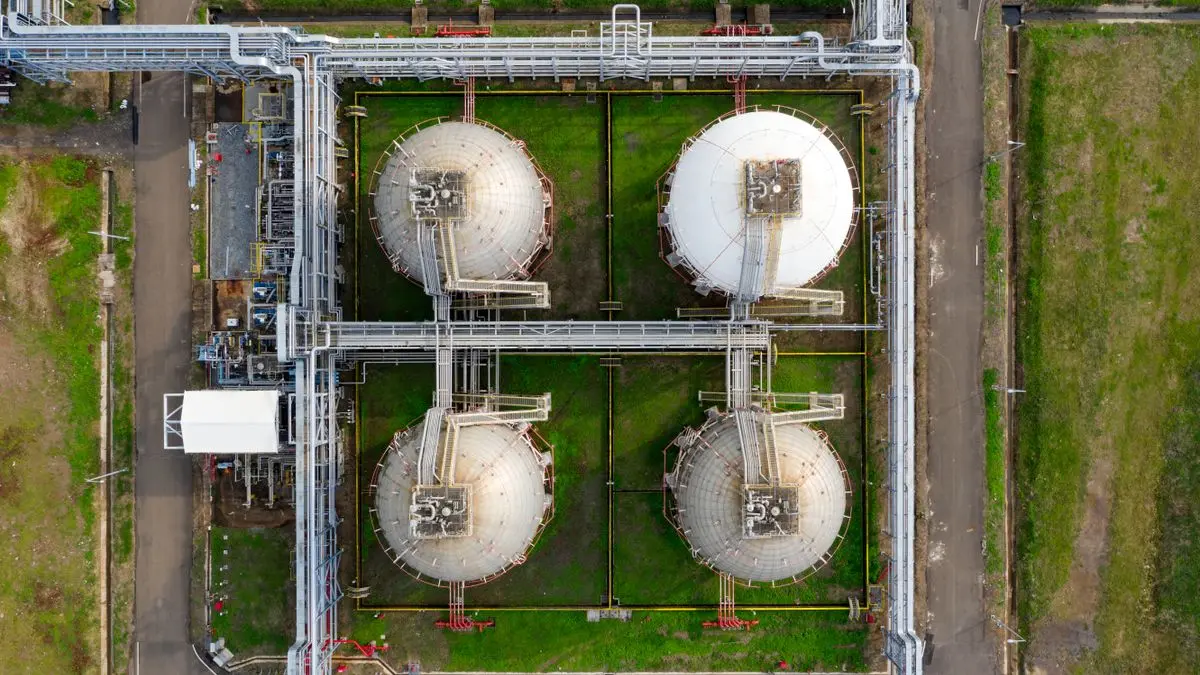 Aerial view of large industrial storage tanks.