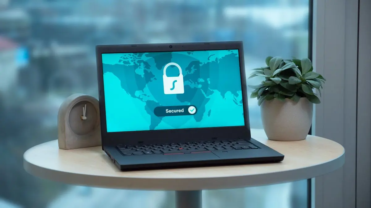 A laptop displays a padlock symbol.