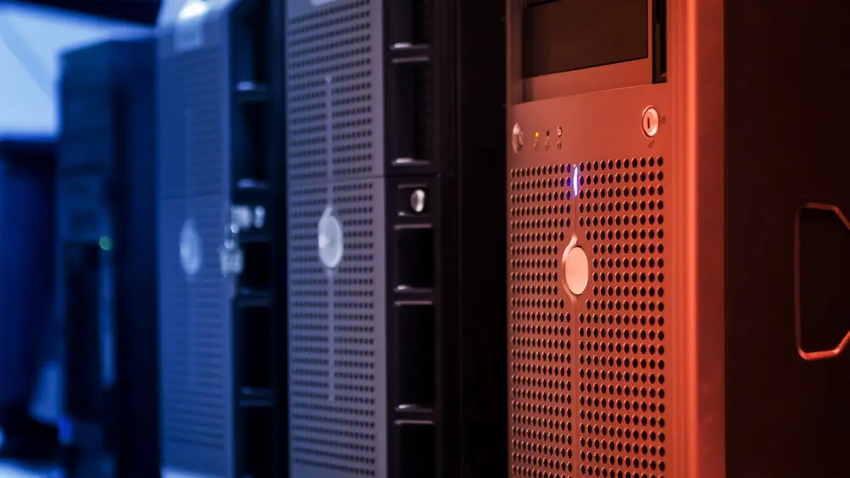 Server cabinets illuminated in blue and red.