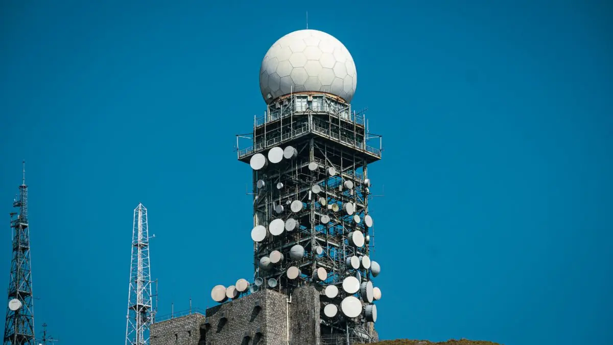 Communications tower fitted with antennas and dishes.